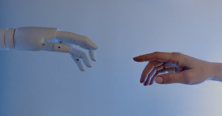 A robot hand reaching for a human to demonstrate how robots are automating healthcare