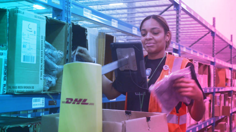 A warehouse employee works with a LocusBot